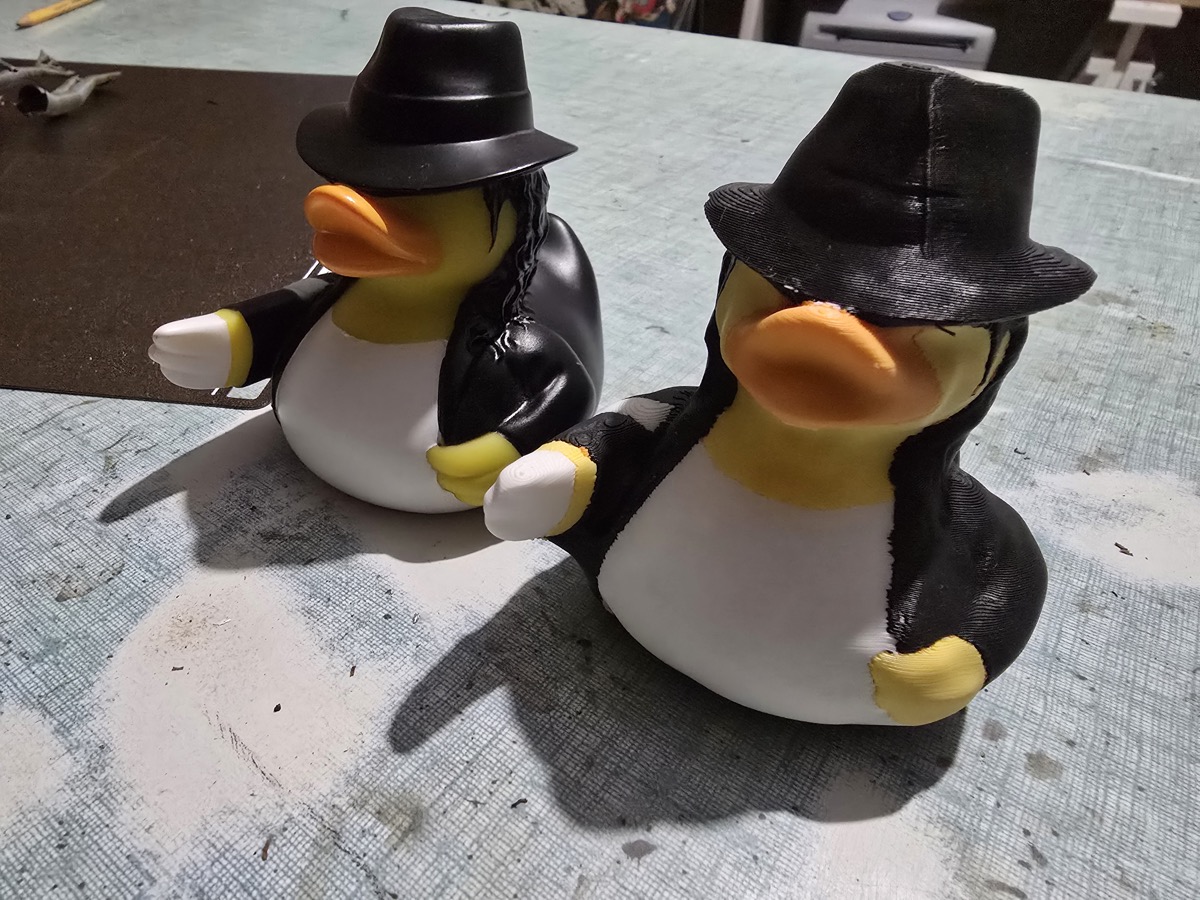 Original rubber duck next to its 3D printed multicolor clone